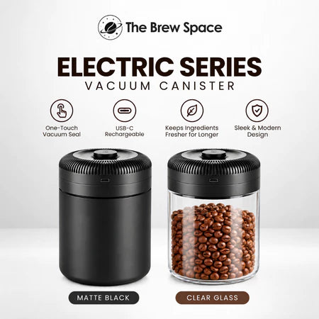 Two vacuum canisters from The Brew Space Electric Series on a light gray background. The left canister is matte black, and the right canister is clear glass filled with coffee beans, showing the transparent container design.